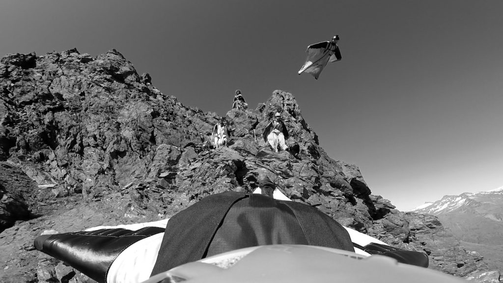 Screenshot from the film Spellbound or wingsuit pilots jumping in New Zealand